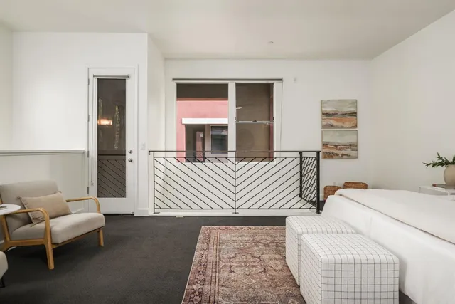 a bedroom with a bed and a couch