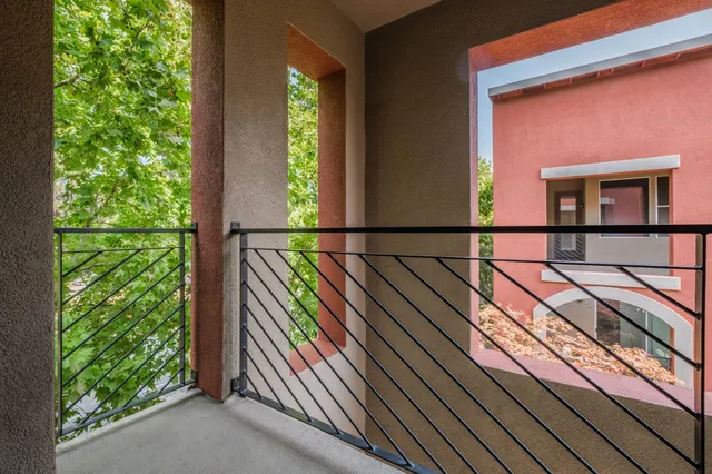 a view of balcony with floor to ceiling windows and wooden floor