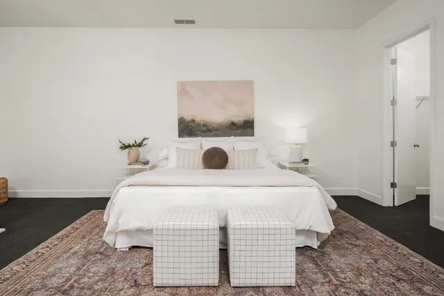 a bedroom with a bed and a night stand