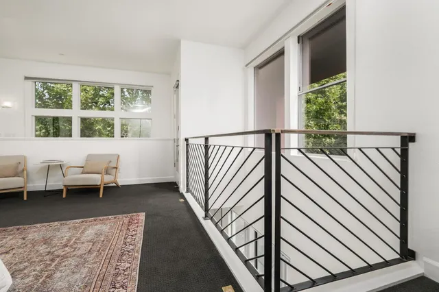 a view of a balcony with furniture and a window