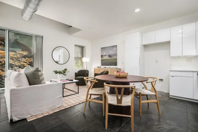 a living room with furniture a rug and a window