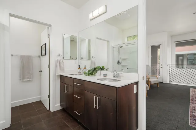 a bathroom with a sink a shower and a mirror