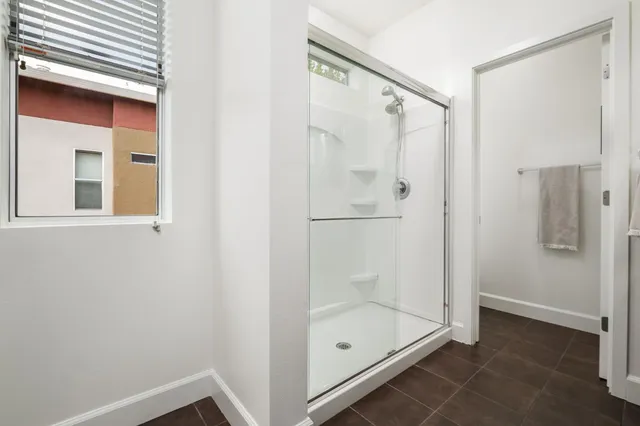 a bathroom with a glass shower door