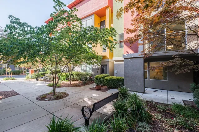 a view of a patio with table and chairs and potted plants