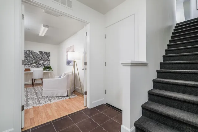 a view of entryway and hall with wooden floor