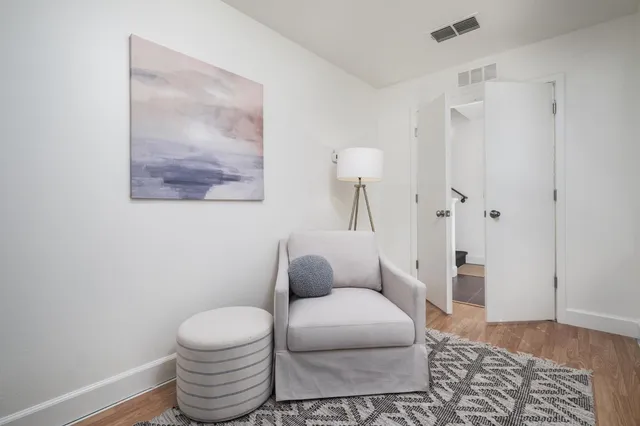 a bathroom with a toilet and a rug