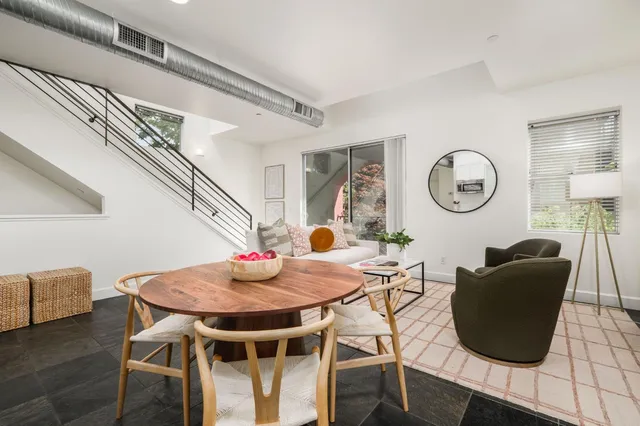 a dining room with furniture and a clock