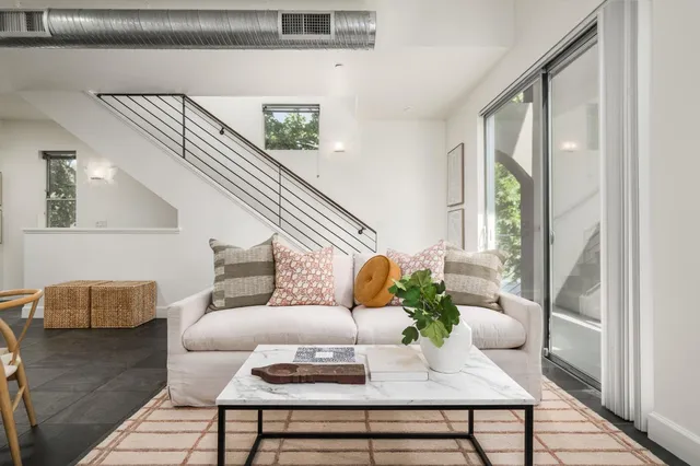 a living room with furniture and wooden floor