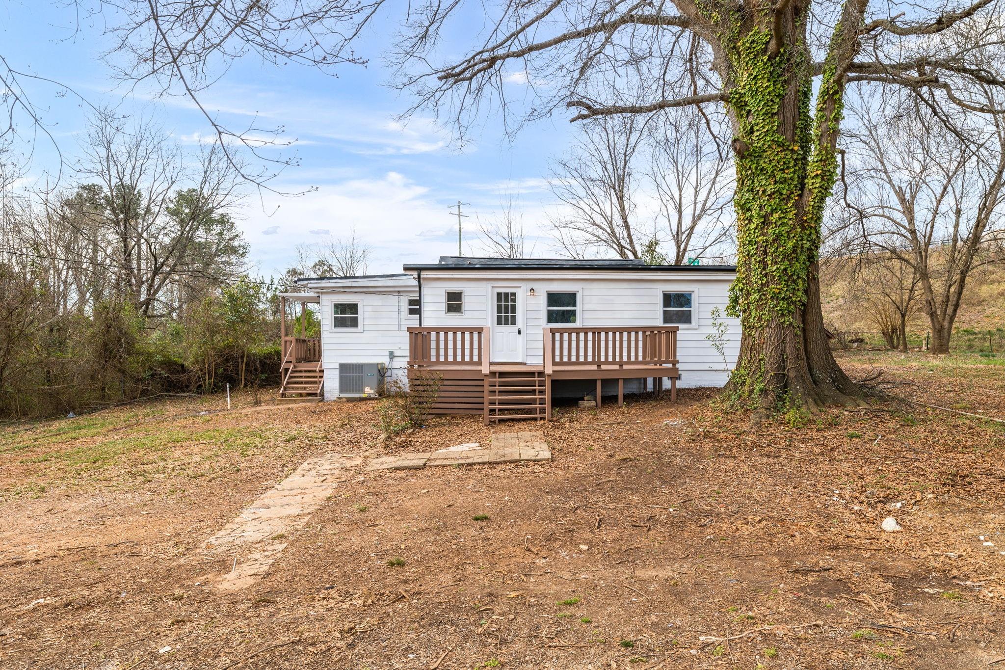 245 Madison Road China Grove, NC 28023 - Photo 1 of 18 a view of a house with a yard covered in snow