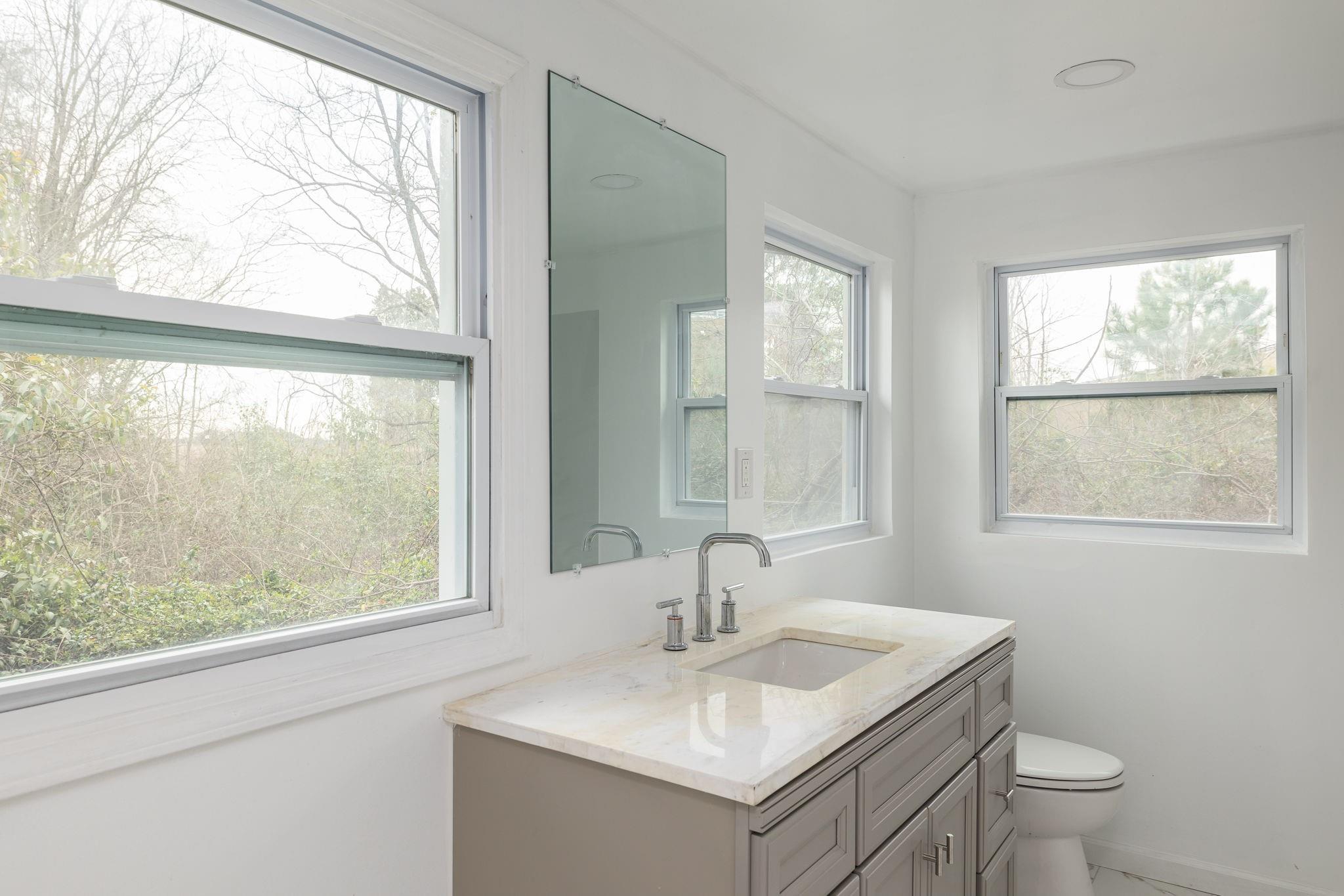 245 Madison Road China Grove, NC 28023 - Photo 11 of 18 a bathroom with a toilet sink and window