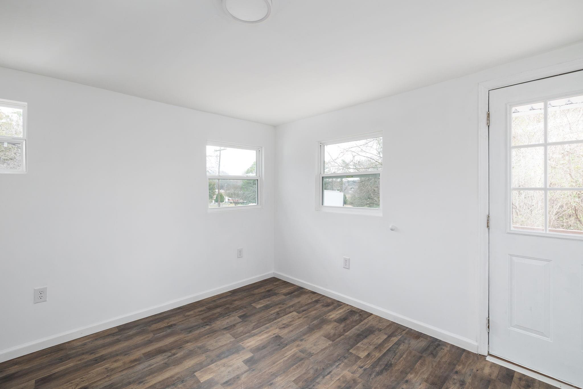 245 Madison Road China Grove, NC 28023 - Photo 12 of 18 an empty room with wooden floor and windows