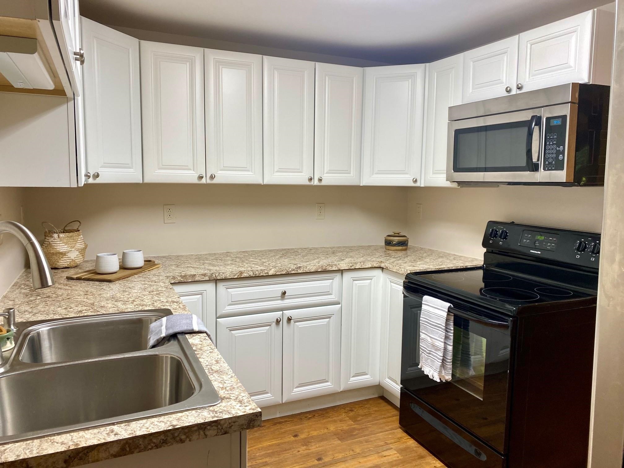 7524 Briery Branch Road Dayton, VA 22821 - Photo 16 of 28 a kitchen with granite countertop a sink stove and microwave