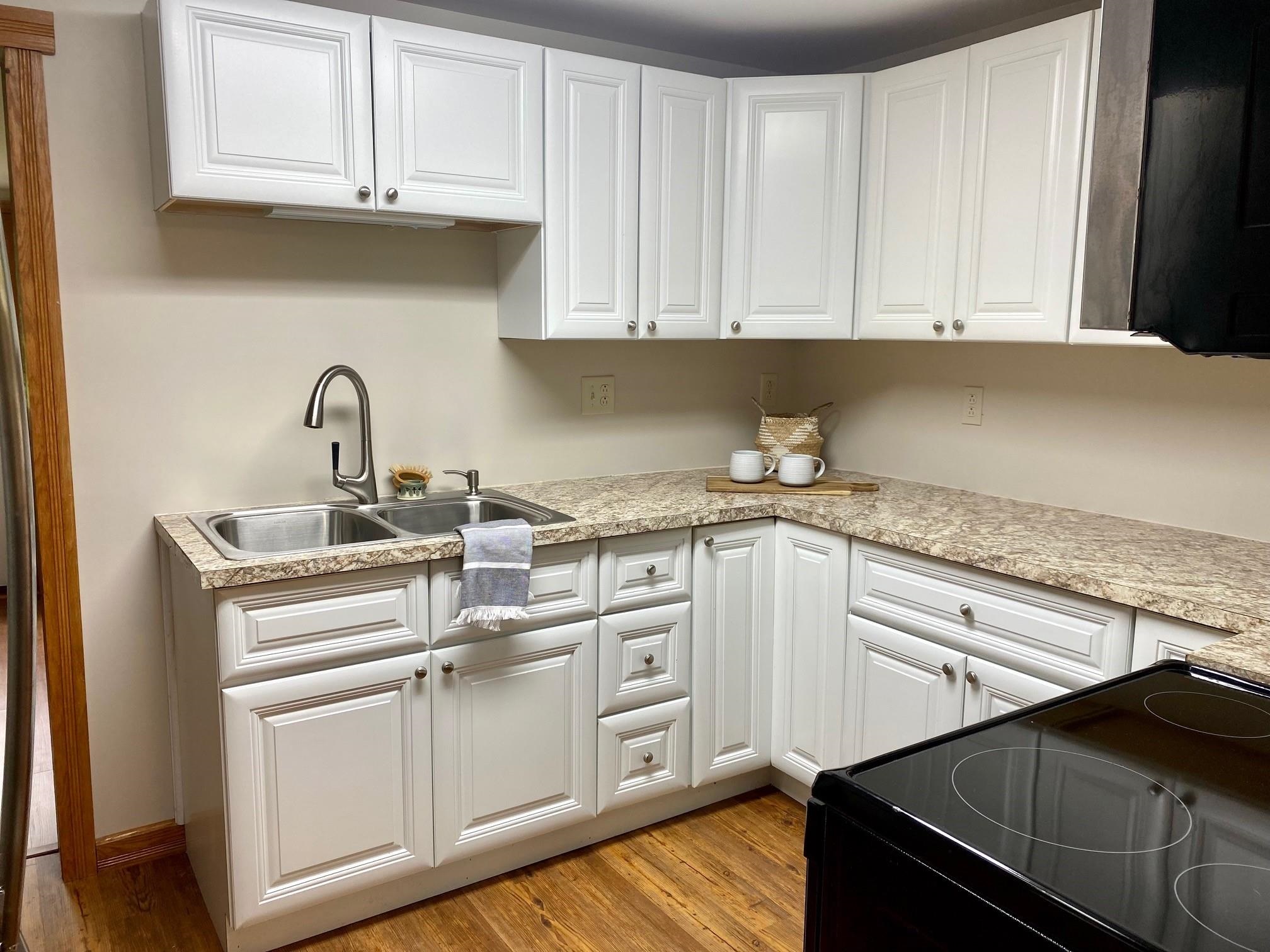 7524 Briery Branch Road Dayton, VA 22821 - Photo 17 of 28 a kitchen with granite countertop white cabinets and white appliances