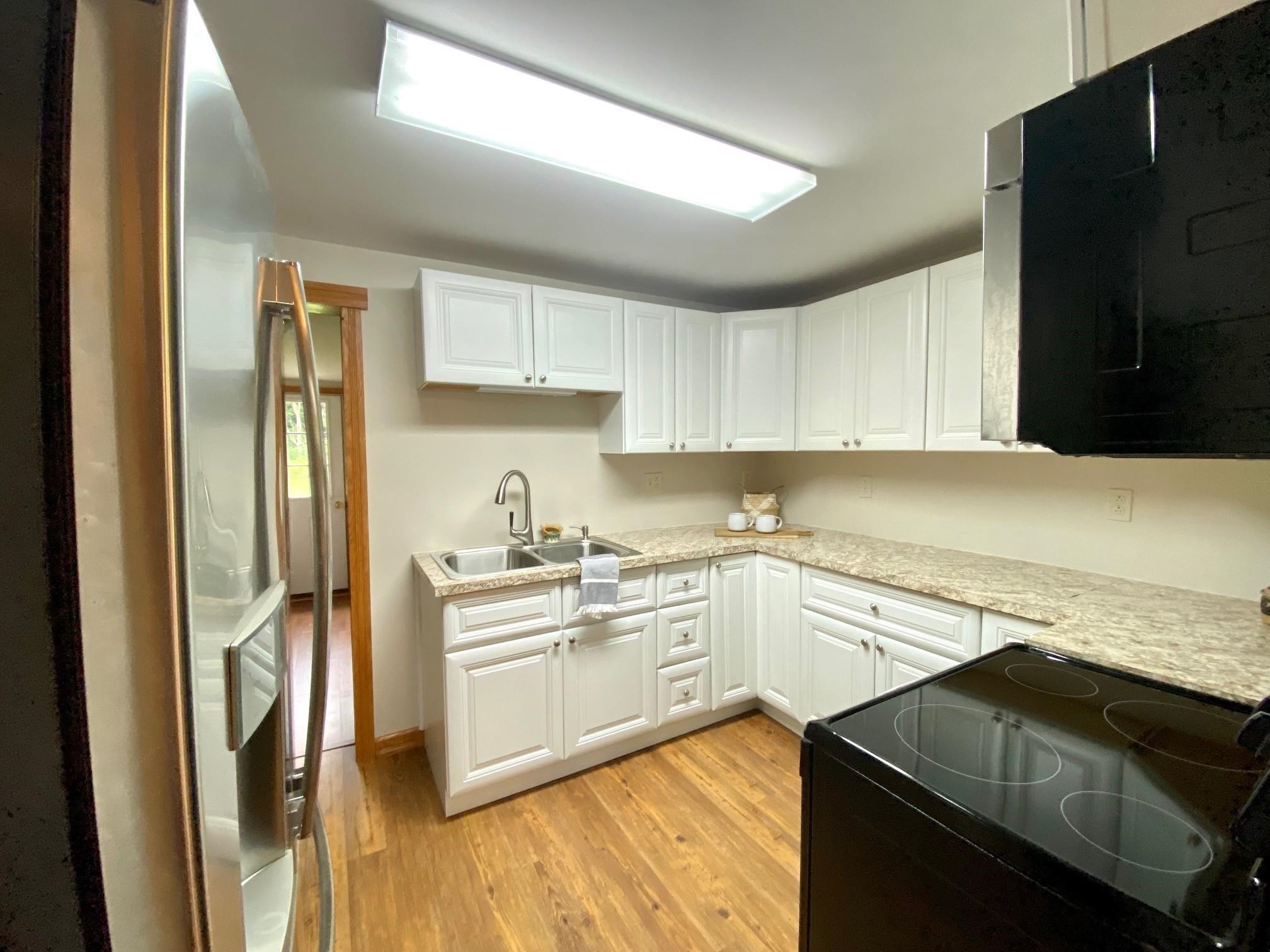 7524 Briery Branch Road Dayton, VA 22821 - Photo 18 of 28 a kitchen with stainless steel appliances granite countertop a refrigerator and a stove top oven