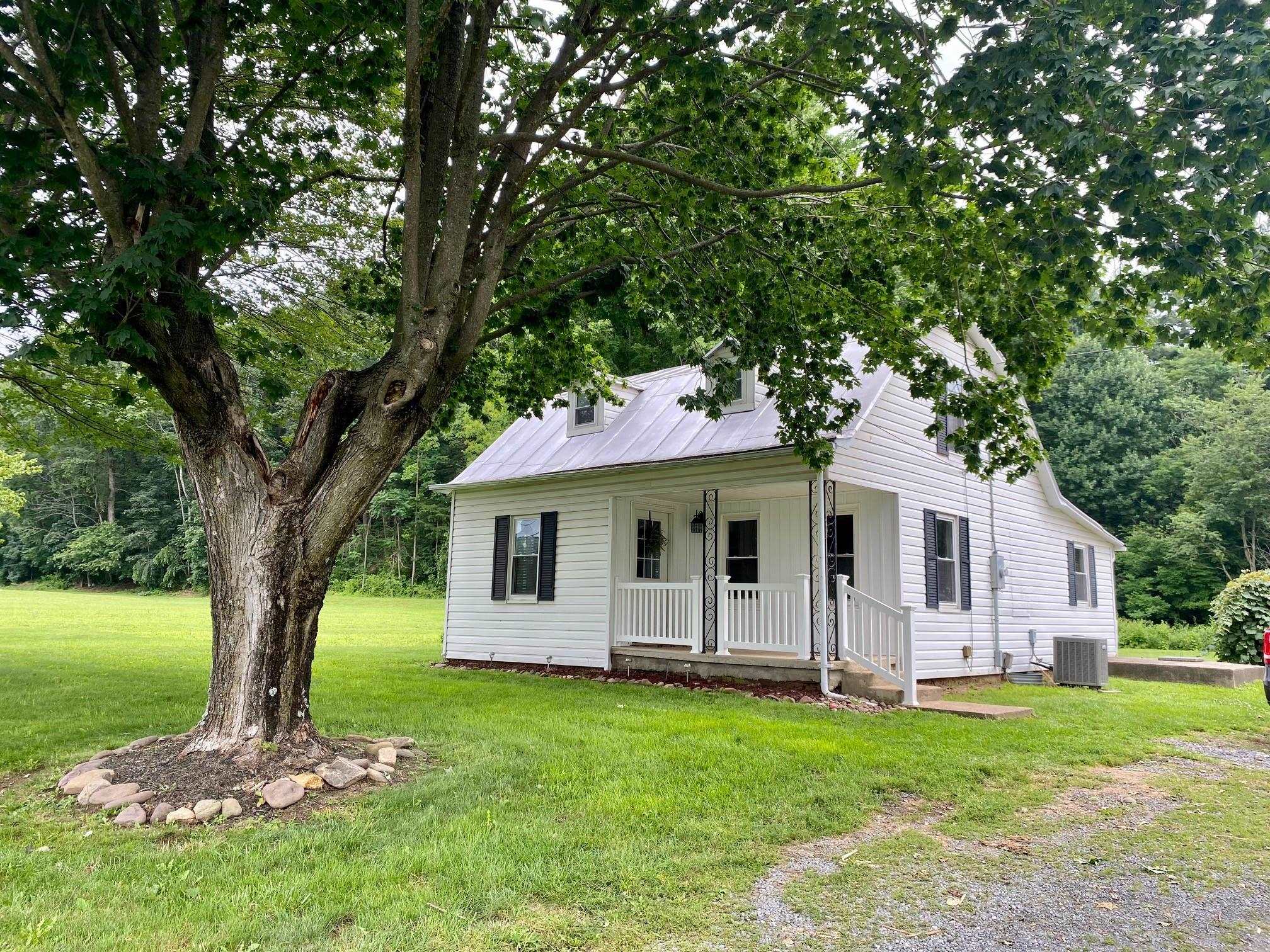 7524 Briery Branch Road Dayton, VA 22821 - Photo 2 of 28 a front view of house with yard and green space