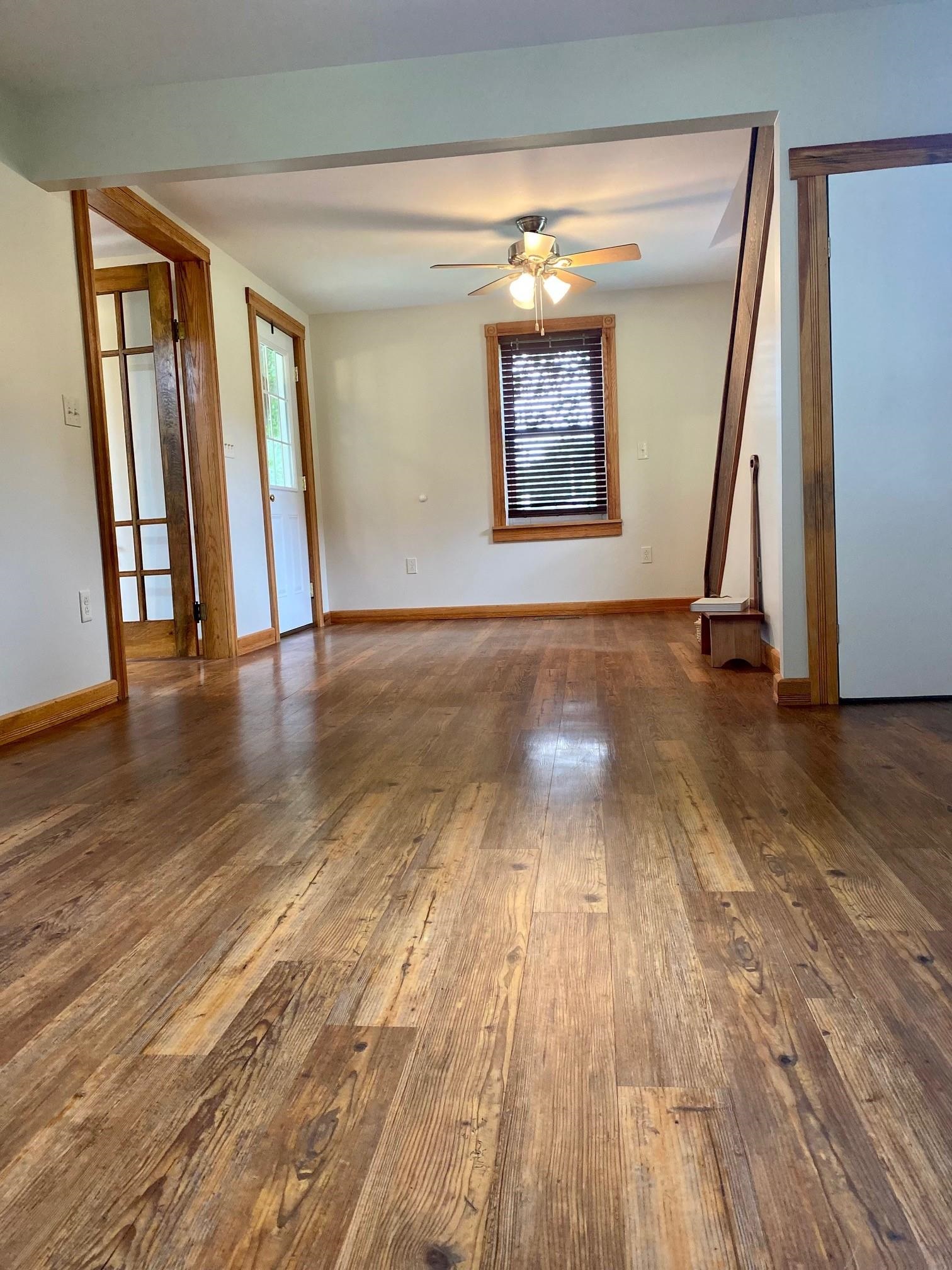 7524 Briery Branch Road Dayton, VA 22821 - Photo 6 of 28 a view of an empty room with wooden floor and a window