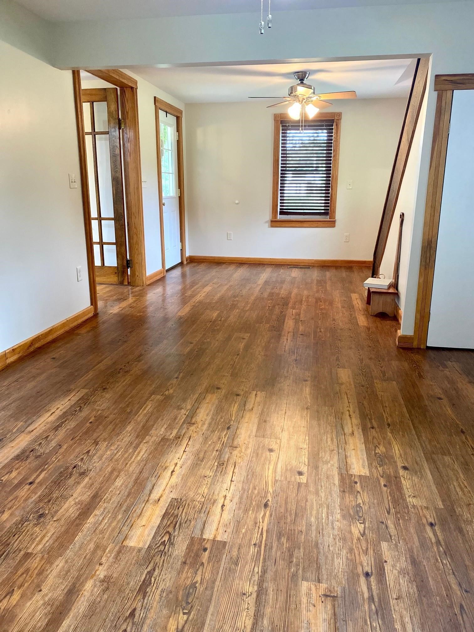 7524 Briery Branch Road Dayton, VA 22821 - Photo 7 of 28 a view of an empty room with wooden floor and a window
