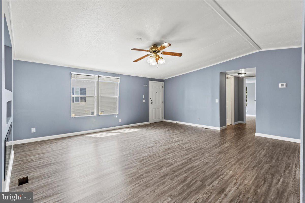 308 Berts Drive Lothian, MD 20711 - Photo 13 of 26 wooden floor in an empty room with a window