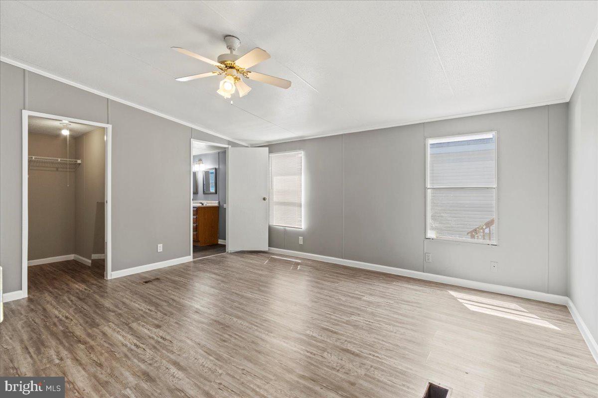 308 Berts Drive Lothian, MD 20711 - Photo 17 of 26 a view of an empty room with wooden floor and a window