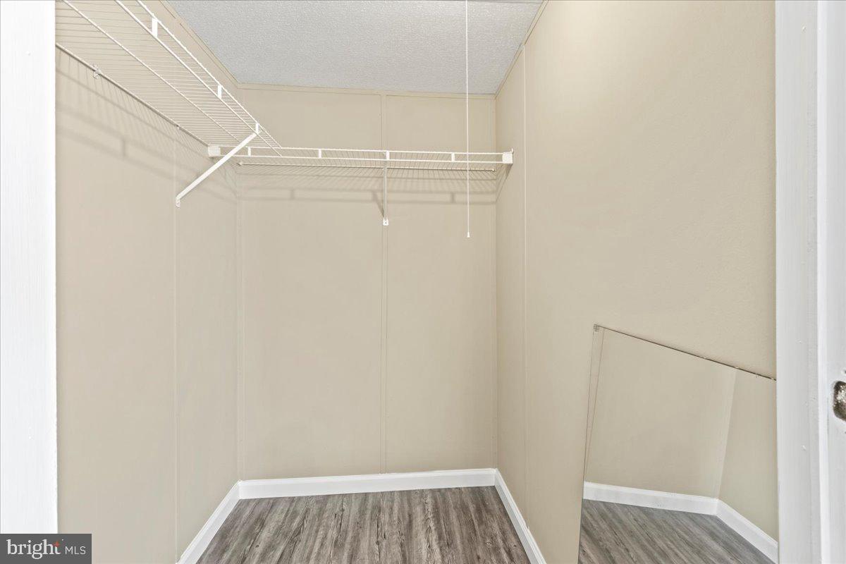 308 Berts Drive Lothian, MD 20711 - Photo 19 of 26 a view of closet with wooden floor