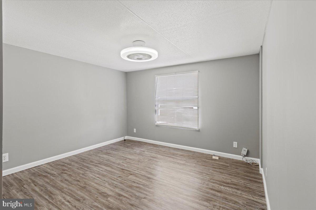 308 Berts Drive Lothian, MD 20711 - Photo 23 of 26 an empty room with wooden floor and windows