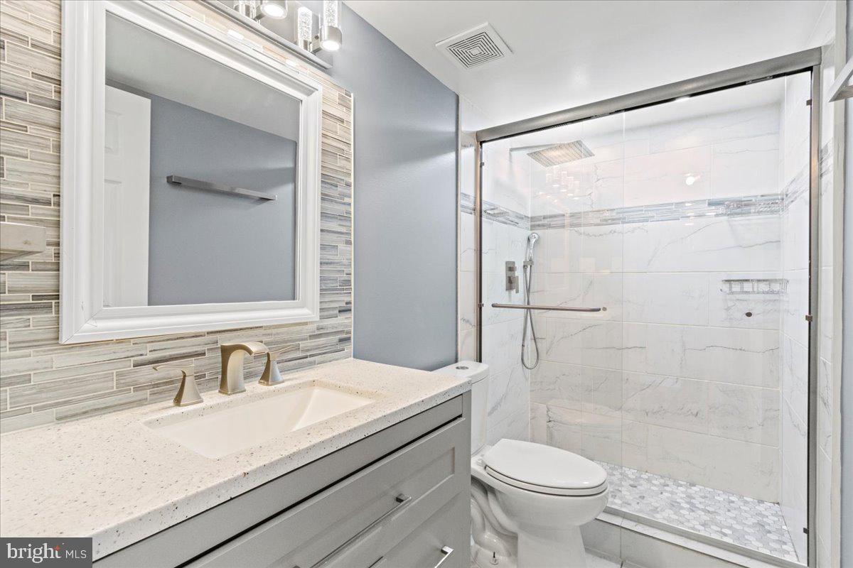 308 Berts Drive Lothian, MD 20711 - Photo 24 of 26 a bathroom with a sink toilet and shower
