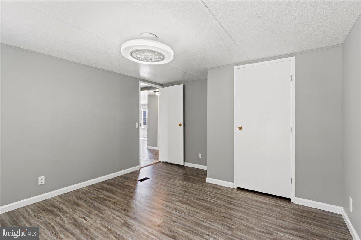 308 Berts Drive Lothian, MD 20711 - Photo 25 of 26 a view of an empty room with wooden floor