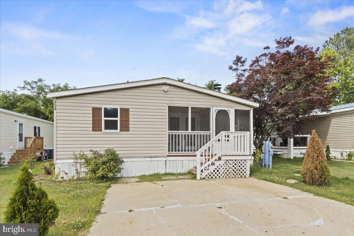 308 Berts Drive Lothian, MD 20711 - Photo 4 of 26 a front view of a house with a garden