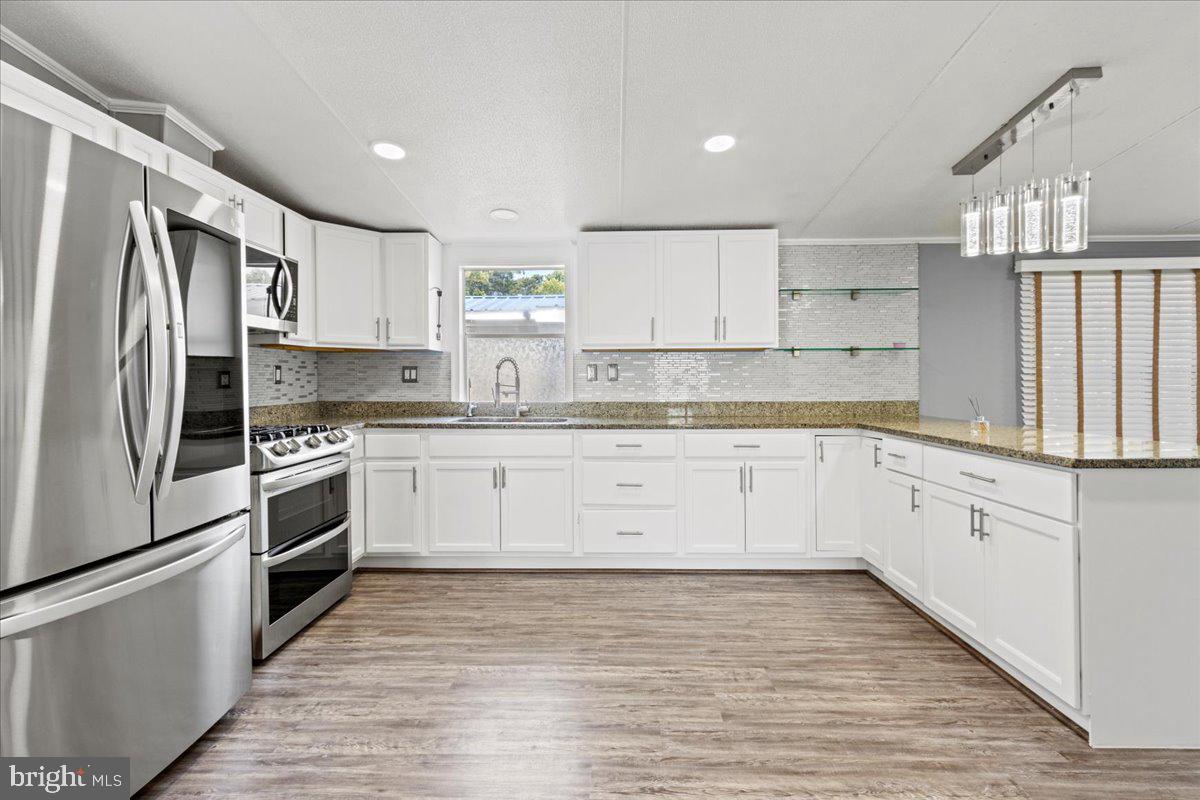 308 Berts Drive Lothian, MD 20711 - Photo 9 of 26 a kitchen with granite countertop white cabinets and stainless steel appliances