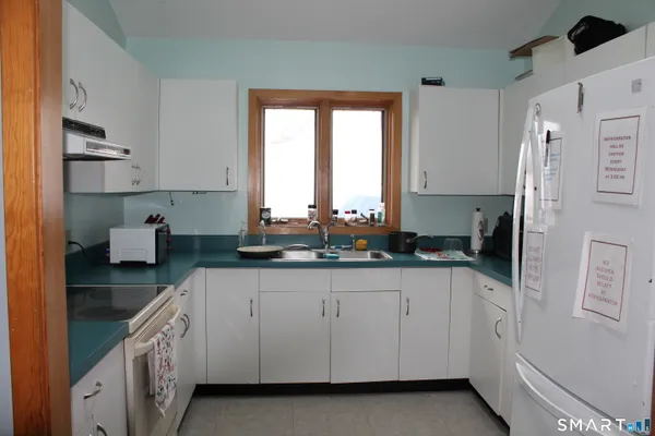 a kitchen with stainless steel appliances granite countertop a sink and cabinets