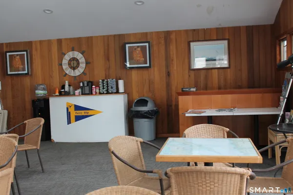 a living room with a cabinet and a lamp
