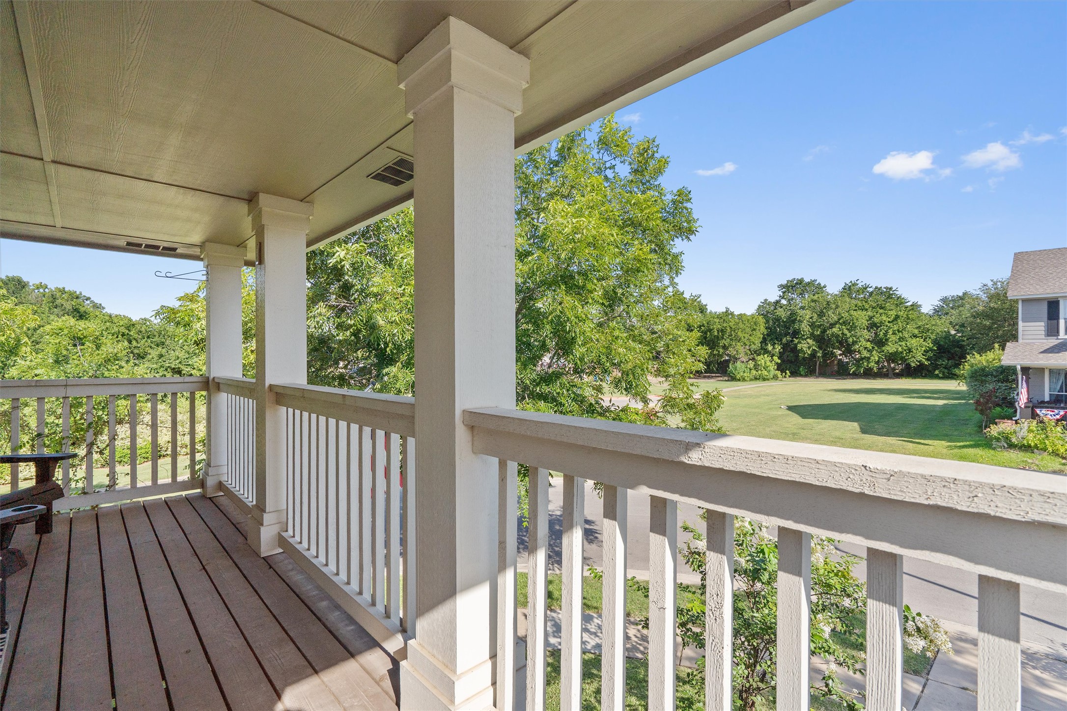 1833 Thompson Trail Round Rock, TX 78664 - Photo 25 of 40 Relax on the covered deck overlooking a verdant lawn and street with mature trees.