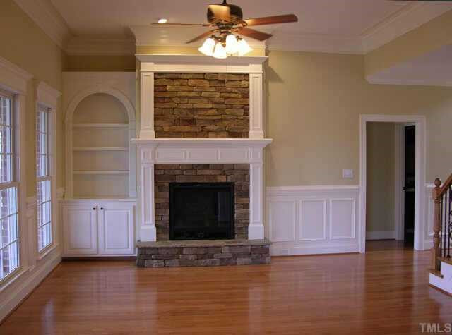 3313 Cotton Road Raleigh, NC 27601 - Photo 10 of 10 Very open floor plan includes large family room featuring beautiful fireplace with stacked stone surround, mantle, expansive trim, wainscoting and built-ins. Other