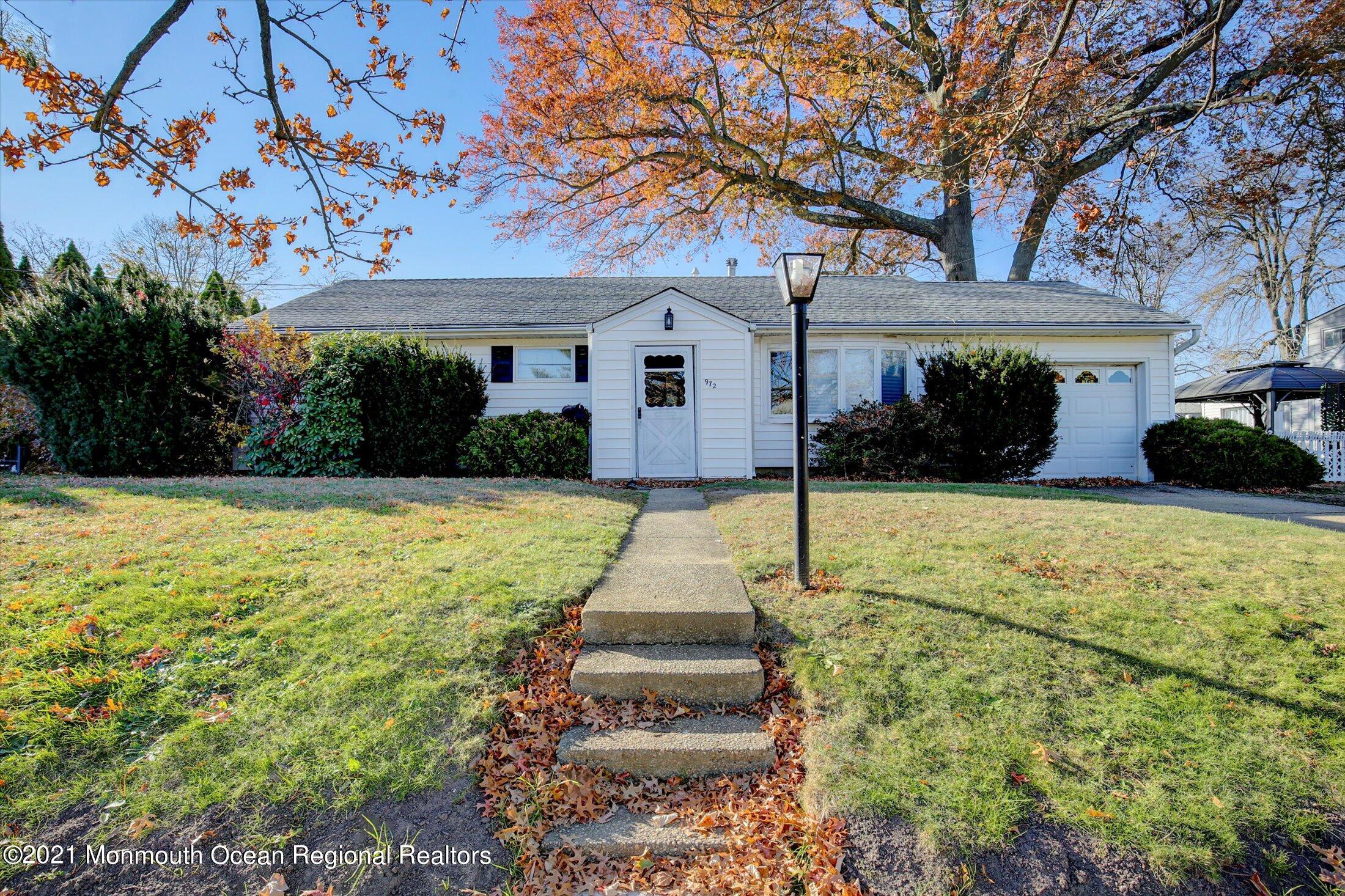 972 Woodgate Avenue Long Branch, NJ 07740 - Photo 1 of 20 a front view of a house with a yard and potted plants