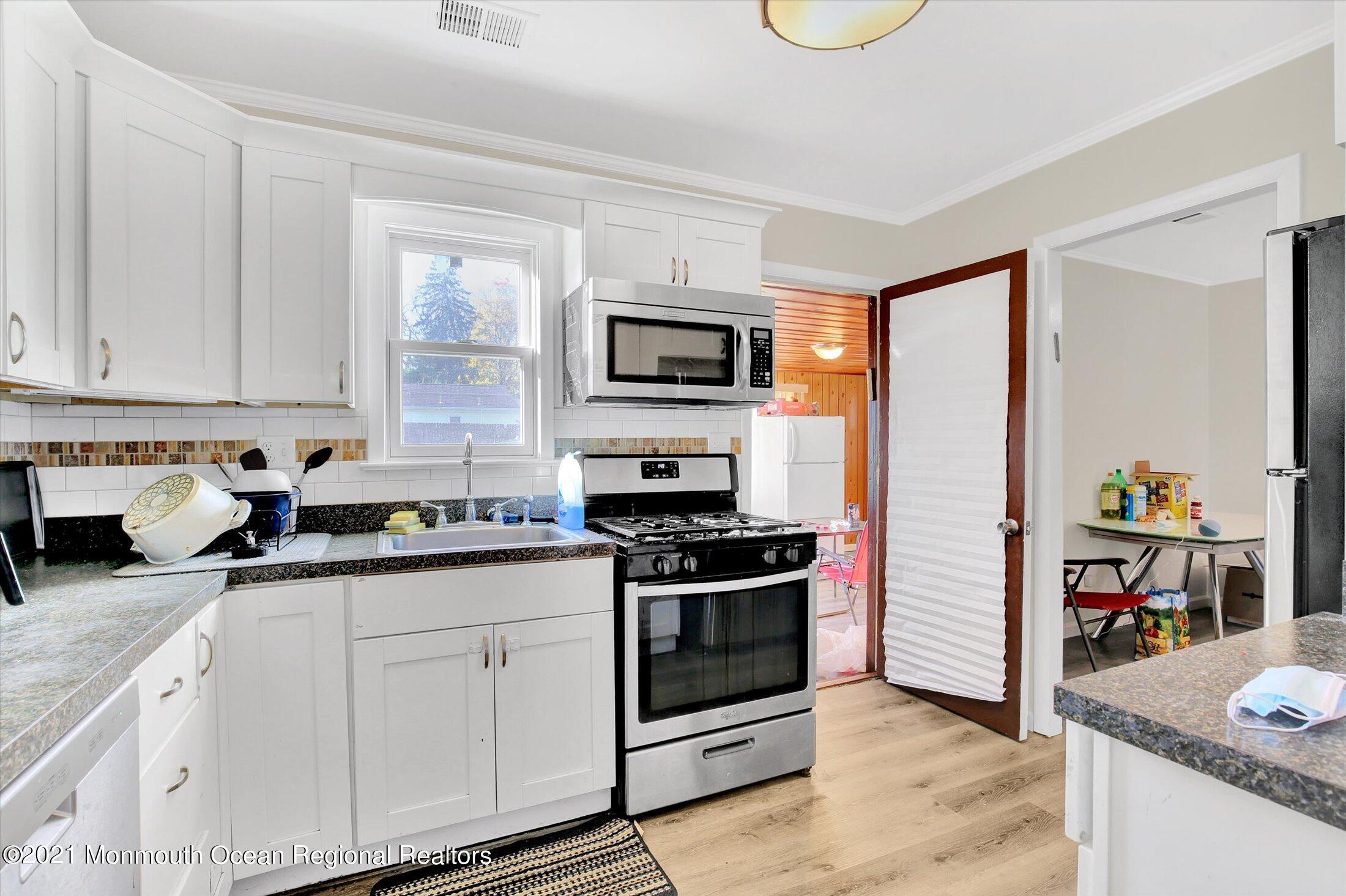 972 Woodgate Avenue Long Branch, NJ 07740 - Photo 11 of 20 a kitchen with stainless steel appliances granite countertop a stove and a sink