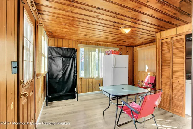a patio with table and chairs and potted plants