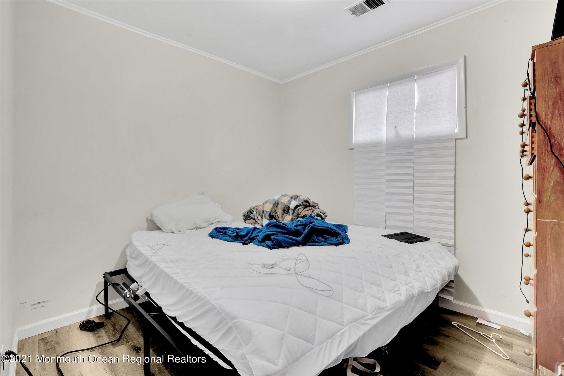 972 Woodgate Avenue Long Branch, NJ 07740 - Photo 16 of 20 a bedroom with a bed and a table