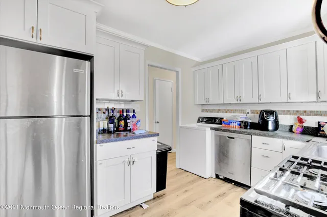 a kitchen with stainless steel appliances a refrigerator sink and cabinets