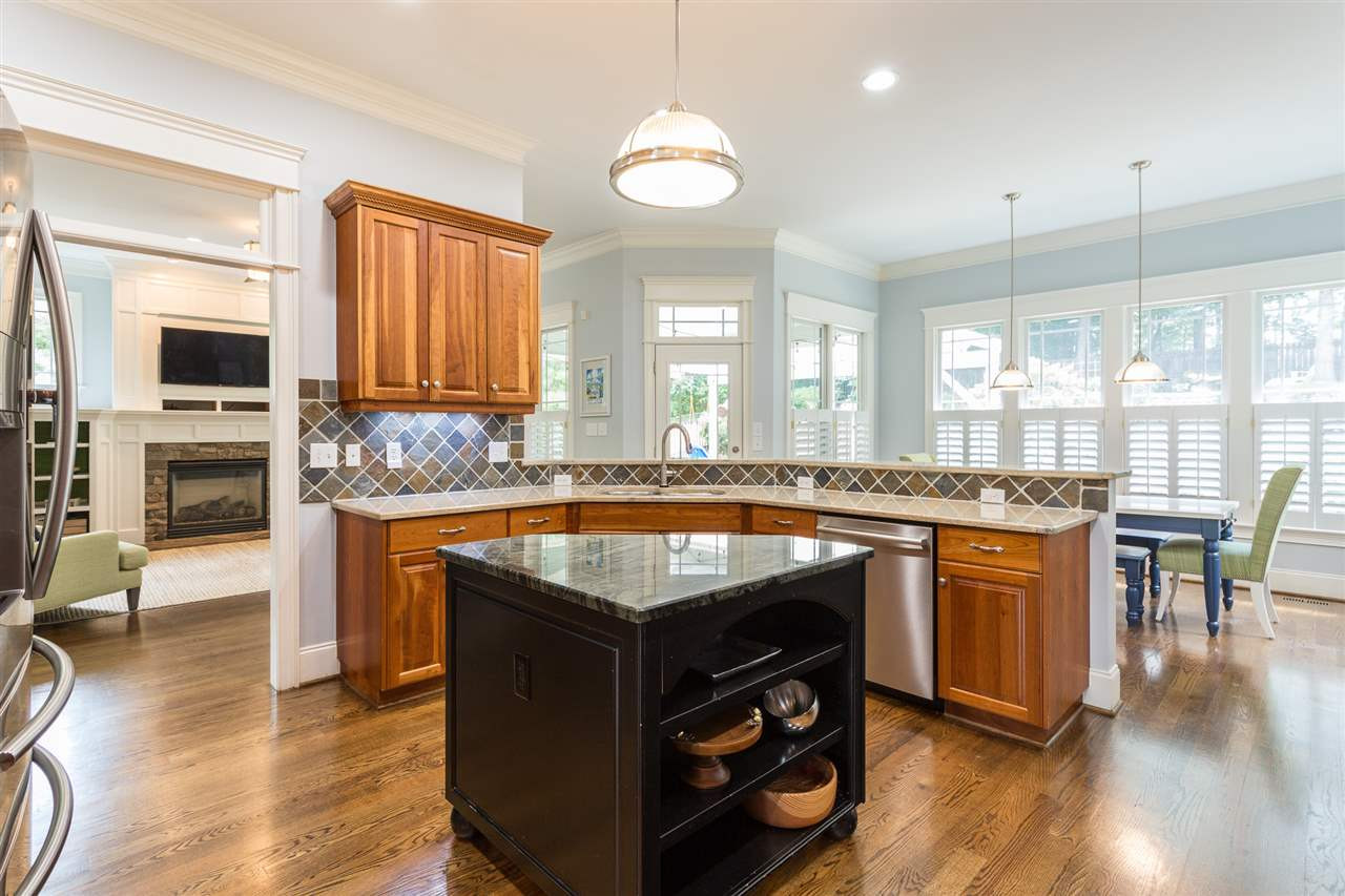 1716 Stannard Trail Raleigh, NC 27612 - Photo 10 of 30 Additional features of the kitchen include a new pendant light over the central island, double-door pantry and direct access to the mudroom. Kitchen