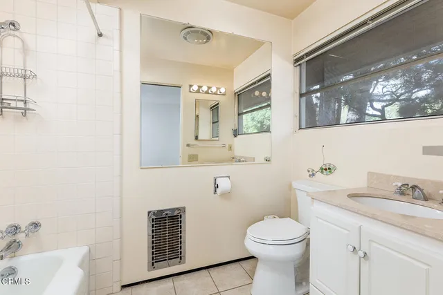 a bathroom with a sink a toilet and mirror