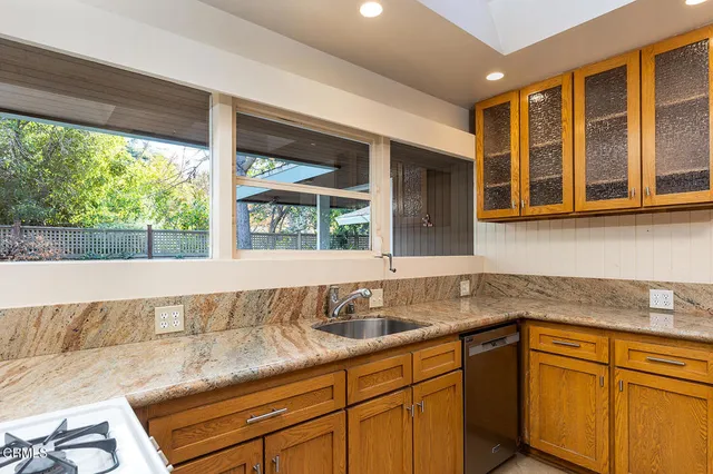 a kitchen with stainless steel appliances granite countertop a sink and cabinets