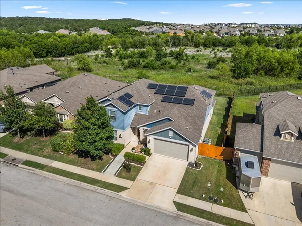 an aerial view of residential houses with outdoor space and street view