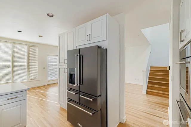 a kitchen with stainless steel appliances a refrigerator and cabinets
