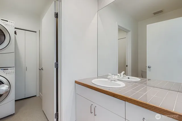 a bathroom with a sink a toilet and a mirror