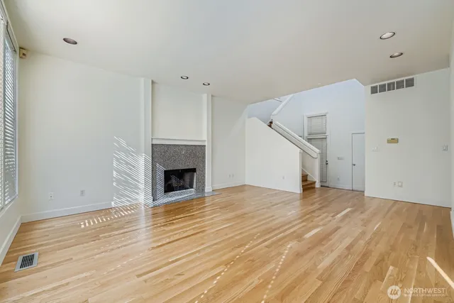 a view of a room with wooden floor and fireplace