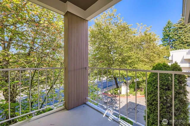 a balcony with trees in front of it