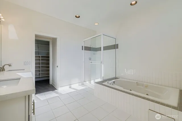 a bathroom with a tub sink and mirror