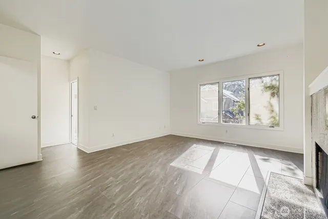 an empty room with wooden floor and window