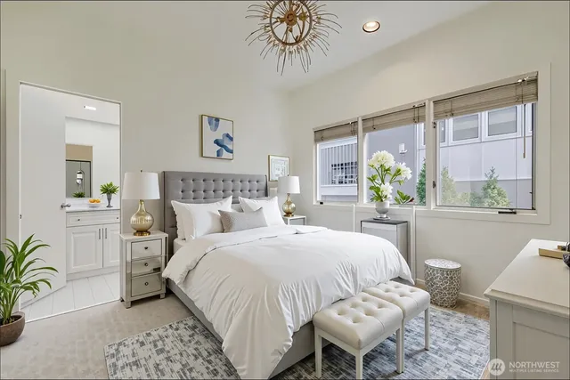 a bedroom with a bed and a chandelier