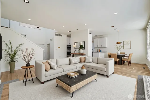 a living room with furniture a rug and a table